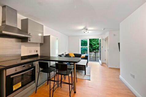 A modern kitchen and dining area featuring slee...