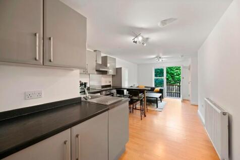 Bright and modern kitchen space featuring sleek...