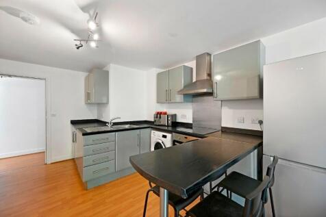 Modern kitchen featuring sleek cabinetry, a bre...