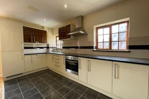 Bright and modern kitchen featuring ample count...