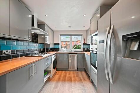 A modern and well-equipped kitchen featuring sl...