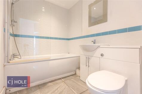 A modern bathroom suite featuring a clean white...