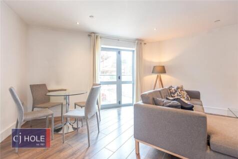Bright and modern living room featuring a comfo...