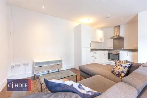Bright and contemporary living room featuring a...