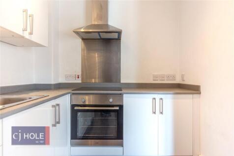 A modern and clean kitchen featuring a built-in...