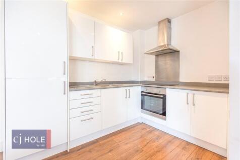 Bright and modern kitchen with sleek white cabi...
