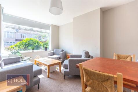 Bright and inviting living room featuring large...