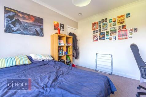 A cozy double bedroom featuring a comfortable d...