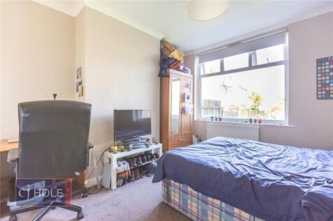 A bright and welcoming double bedroom featuring...