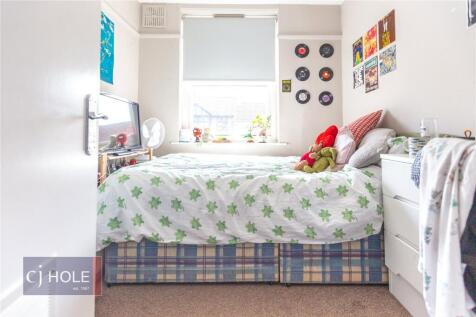 Bright and cozy single bedroom featuring a comf...