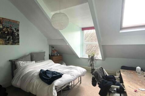A bright and inviting master bedroom featuring ...