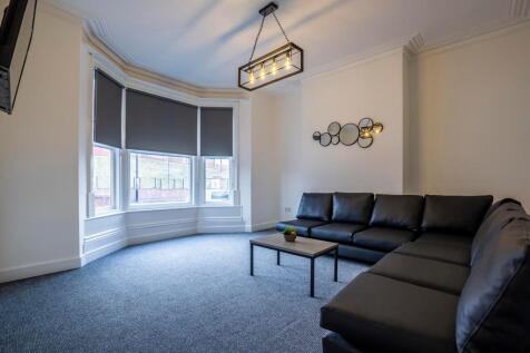 A spacious and inviting living room featuring a...