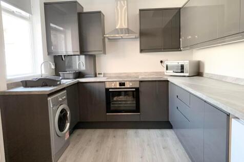 Modern kitchen with sleek grey cabinetry and li...