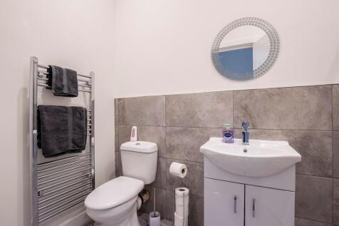 A clean and modern bathroom featuring a white t...