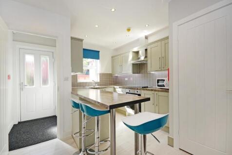 Bright and modern kitchen featuring a breakfast...