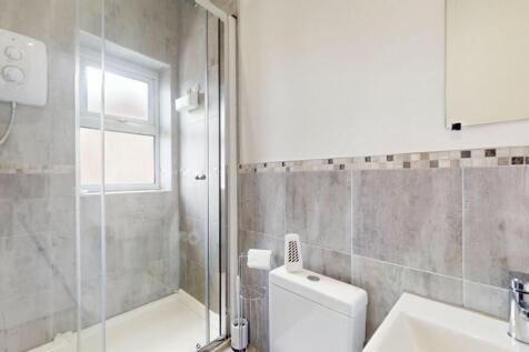 Bright and modern bathroom suite featuring a sp...