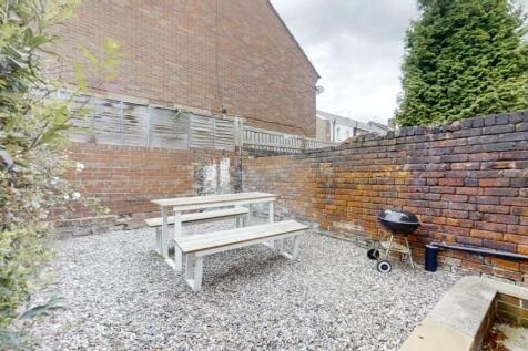 A private outdoor garden space featuring a picn...