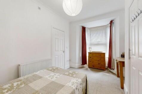 A bright and cozy double bedroom featuring a co...