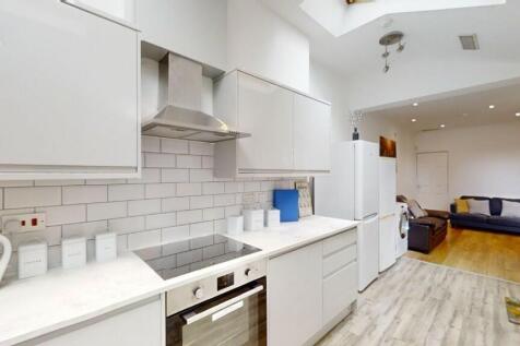 A bright and modern kitchen with white cabinetr...