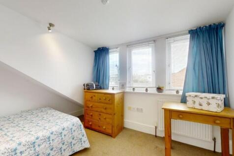 Cozy single bedroom featuring a comfortable bed...