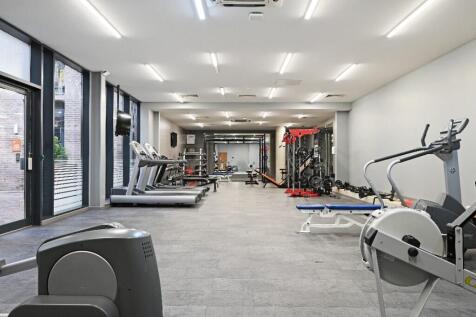 A modern and well-equipped gym featuring treadm...