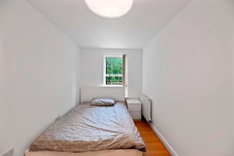 A simple, clean single bedroom with white walls...