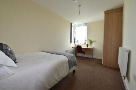 A bright and tidy single bedroom featuring a co...