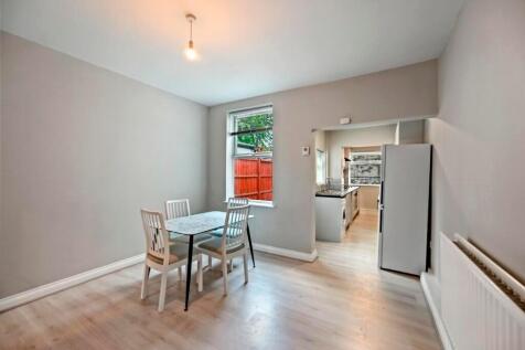 Bright and tidy dining area adjacent to a moder...