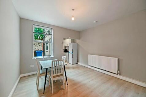 Bright and clean kitchen area featuring light w...