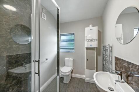 A modern bathroom featuring a large walk-in sho...