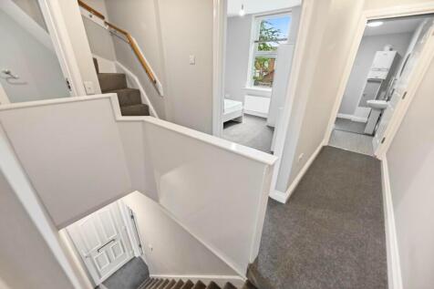 Bright and clean hallway featuring neutral deco...
