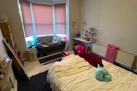 Bright and cozy master bedroom featuring a larg...