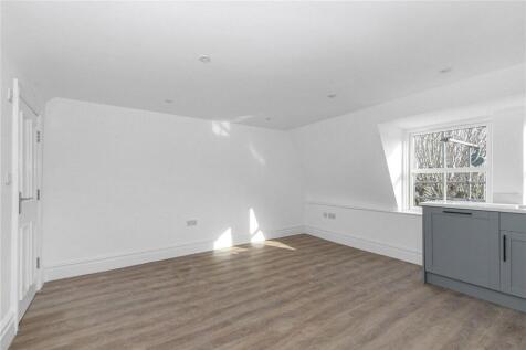 Bright and spacious living room featuring clean...