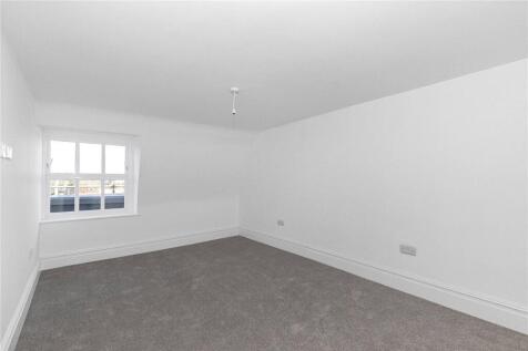 A clean and spacious double bedroom featuring n...