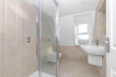 Bright and modern bathroom suite featuring a sp...