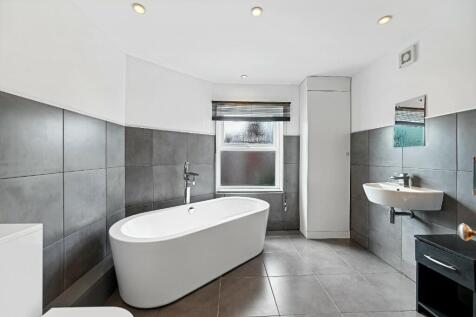 A modern and stylish bathroom featuring a frees...