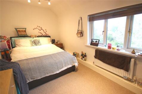 A bright and inviting master bedroom featuring ...