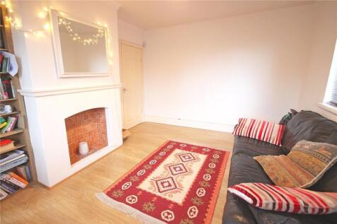 A cozy living room featuring a comfortable dark...