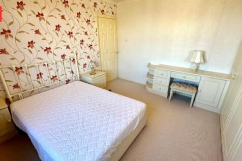 Bright and cozy double bedroom featuring a comf...