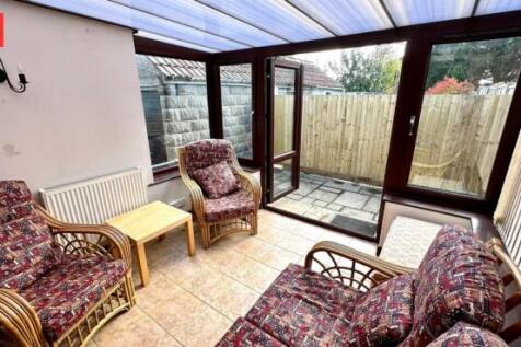 A bright and inviting living room with large gl...