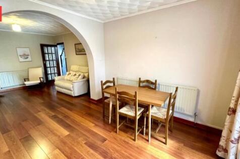 A bright and inviting living room with warm woo...
