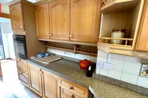Bright and traditional kitchen with ample woode...