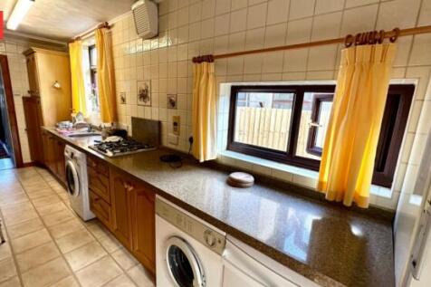 Bright and practical kitchen with ample natural...
