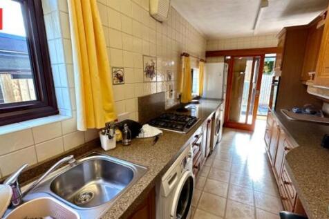 Bright and practical galley kitchen featuring a...