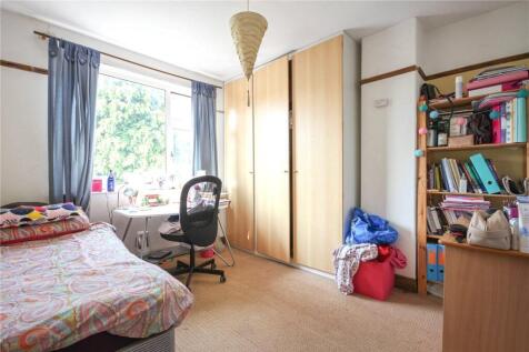 A bright and cozy single bedroom featuring a la...