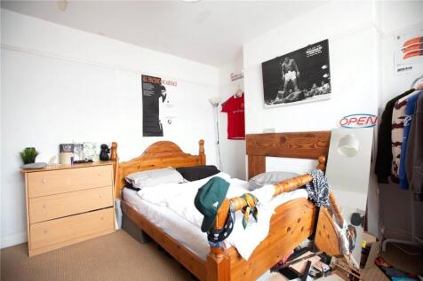 Bright and cozy bedroom featuring a wooden bed ...