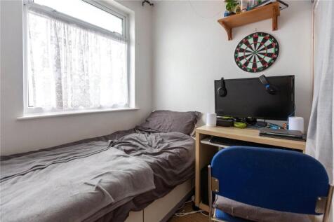 Cozy single bedroom featuring a comfortable bed...