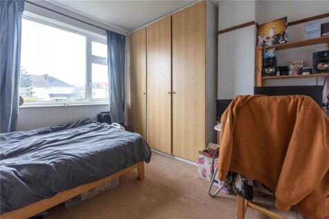 A cozy and well-kept single bedroom featuring a...
