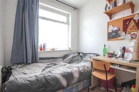 A compact, tidy single bedroom featuring a cozy...