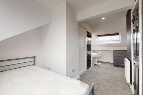 Bright and spacious master bedroom featuring a ...